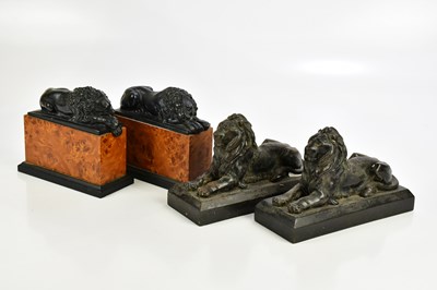 Lot 512 - A pair of cast iron figures of recumbent lions,...