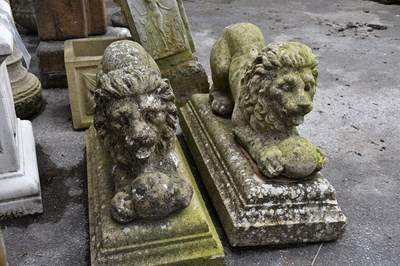 Lot 269 - A pair of composite stone figures of lions, on...