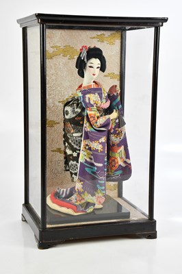 Lot 1153 - A cased model of a geisha in traditional...