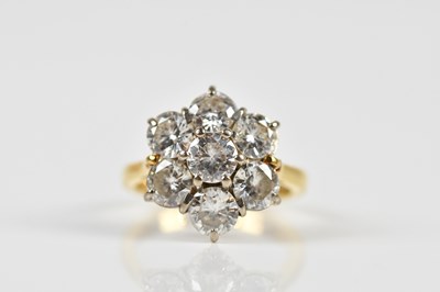 Lot 1272 - An 18ct yellow gold seven stone diamond floral...