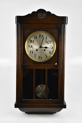 Lot 318 - A 1930s oak cased wall clock, with silvered...