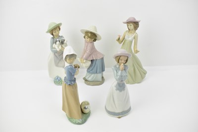 Lot 458 - NAO; five porcelain figures comprising a girl...