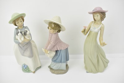 Lot 458 - NAO; five porcelain figures comprising a girl...