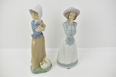 Lot 458 - NAO; five porcelain figures comprising a girl...