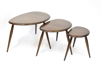 Lot 3 - ERCOL; a nest of three pebble-shaped dark wood...