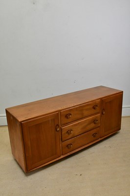 Lot 49 - ERCOL; a medium elm sideboard, with three...