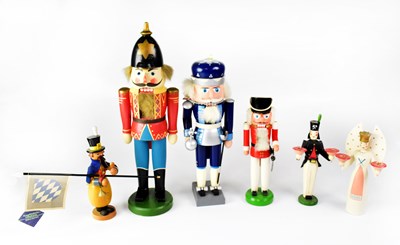 Lot 566 - ERZGEBIRGE; six painted nutcracker-style...