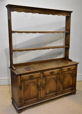 Lot 227 - A modern oak dresser with three drawers over...