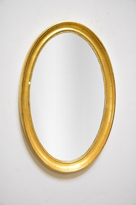 Lot 219 - A gilt framed oval bevelled wall mirror, 85cm...