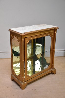 Lot 215 - A French gilt display cabinet with marble top...