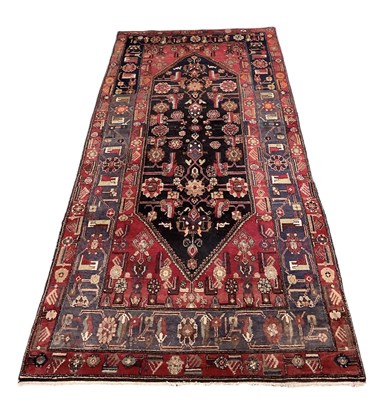 Lot 83 - A Persian type red ground carpet with...