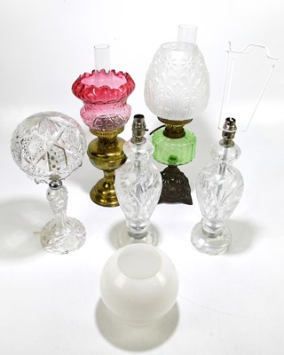 Lot 51 - Three cut glass table lamps, one with a domed...