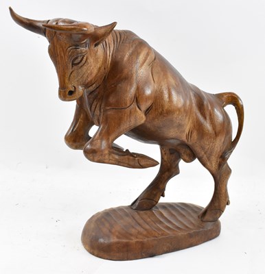 Lot 269 - A large carved wooden figure of a rearing bull,...