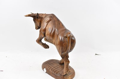 Lot 269 - A large carved wooden figure of a rearing bull,...