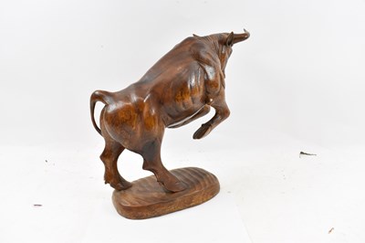 Lot 269 - A large carved wooden figure of a rearing bull,...