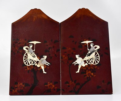 Lot 521 - A pair of Shibayama red lacquered panels...