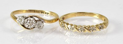 Lot 789 - Two 9ct yellow gold rings, one with cross-over...