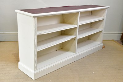 Lot 143 - An Edwardian white painted dwarf open bookcase,...