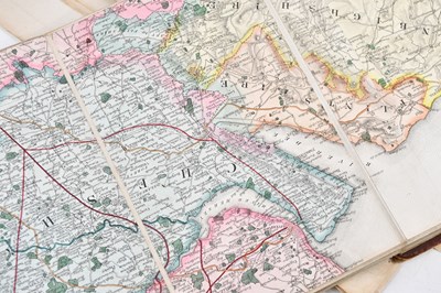 Lot 52 - A 19th century hand coloured linen backed...