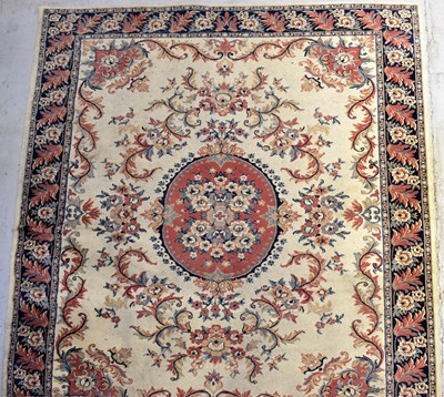 Lot 119 - A wool carpet of cream ground with...