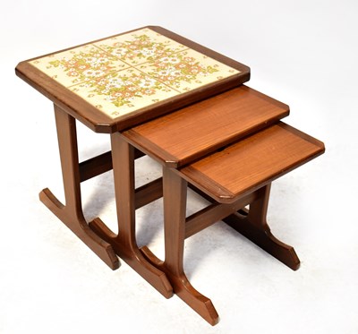 Lot 33 - A retro dark stained teak nest of three tables,...