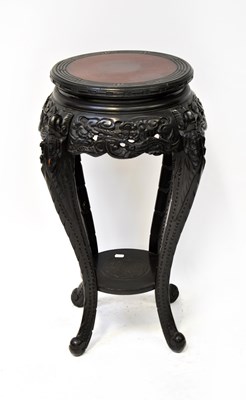 Lot 78 - A Chinese ebonised carved wooden jardinière...