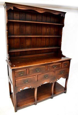 Lot 99 - A Georgian-style oak dresser with an enclosed...