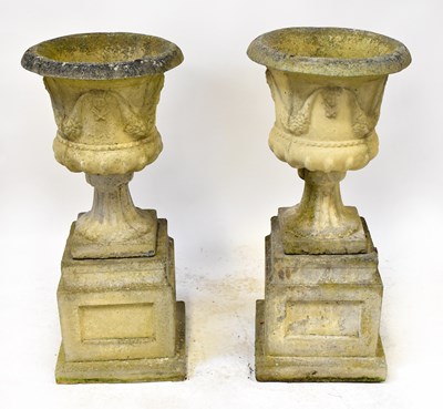 Lot 115 - A pair of reconstituted stone garden urns,...