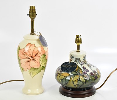 Lot 399 - MOORCROFT; a 'Bramble' pattern lamp, on wooden...