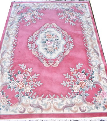 Lot 120 - A pink and cream ground carpet in the...