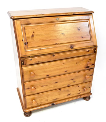 Lot 10 - A 20th century waxed pine bureau, with fall...