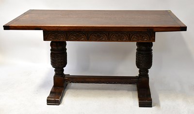 Lot 69 - A reproduction oak extending refectory table,...