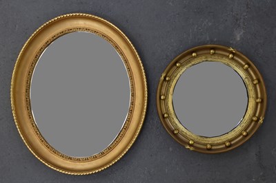 Lot 51 - An oval gilt framed wall mirror, 61 x 52cm,...