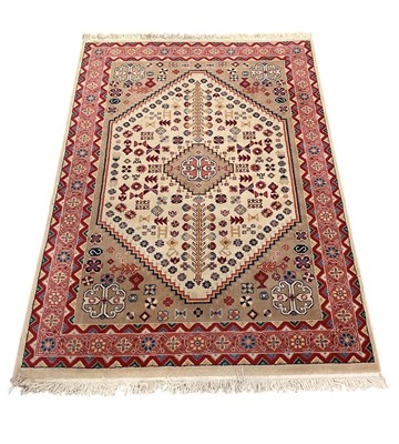 Lot 87 - A modern red and cream ground Iranian carpet...