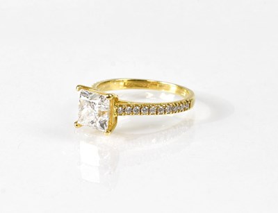 Lot 815 - An 18ct yellow gold ring set with a princess...