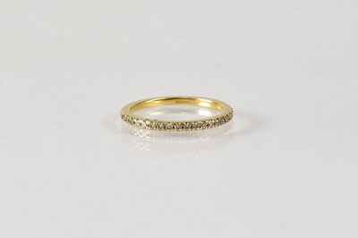 Lot 1061 - An 18ct yellow gold half eternity ring set...