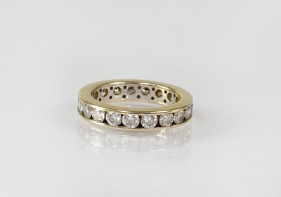 Lot 1060 - An 18ct gold diamond eternity ring, size N,...