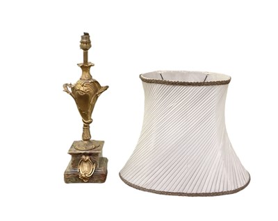 Lot 134 - A gilt metal and onyx table lamp with white...