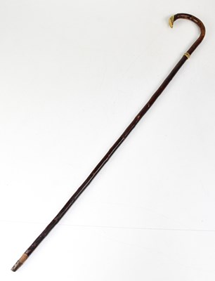 Lot 543 - A walking cane with gold-plated foliate metal...