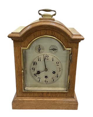 Lot 97 - An early 20th century oak cased mantel clock...