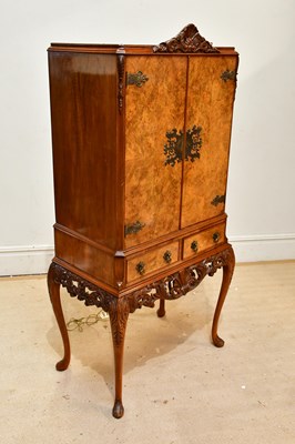 Lot 122 - An Epstein style walnut cocktail cabinet, the...