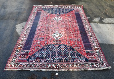 Lot 303 - A large decorative rug with stylised detail on...