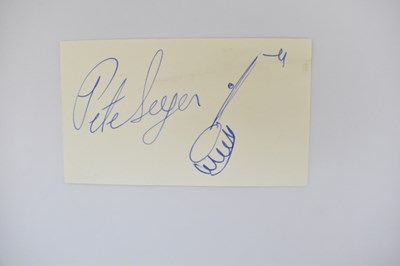 Lot 483 - PETE SEEGER; a small signed card with doodle...