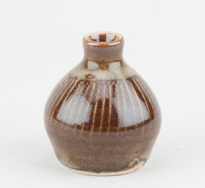 Lot 209 - Leach Pottery; a porcelain bud vase covered in...