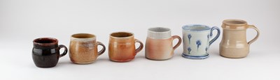 Lot 724 - A group of stoneware mugs by different makers...