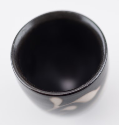 Lot 103 - TIM ANDREWS (born 1960); a raku cup covered in...
