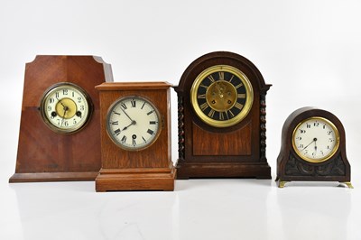 Lot 334 - A 1920s oak mantel clock, the brass and black...