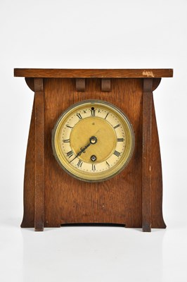 Lot 335 - An Arts and Crafts oak mantel clock, the dial...