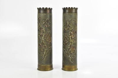 Lot 1365 - A pair of trench art shell casing vases,...