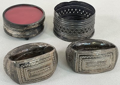 Lot 545 - Two Omani white metal engraved cuffs, an Omani...